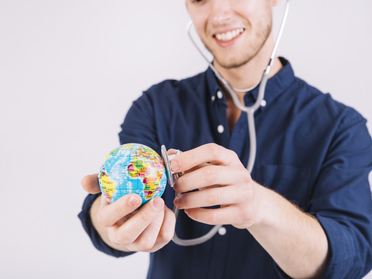 https://nextglobalhealth.com/wp-content/uploads/2024/12/smiling-young-man-examining-globe-with-stethoscope-1280x960.jpg